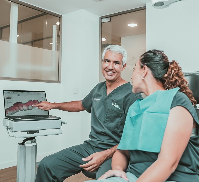 Dentista de Picó&Poveda explicando a una paciente su próxima periodoncia 